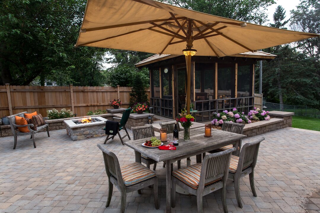Cozy backyard with patio furniture, fire pit, and gazebo.