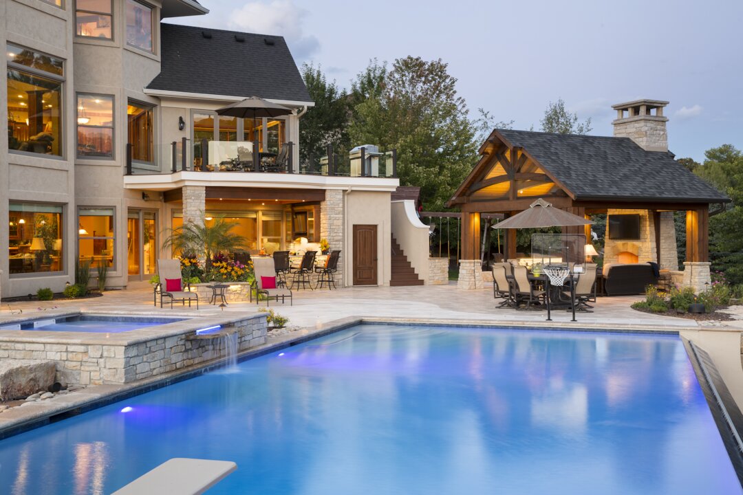 Luxury backyard with pool and outdoor dining area.