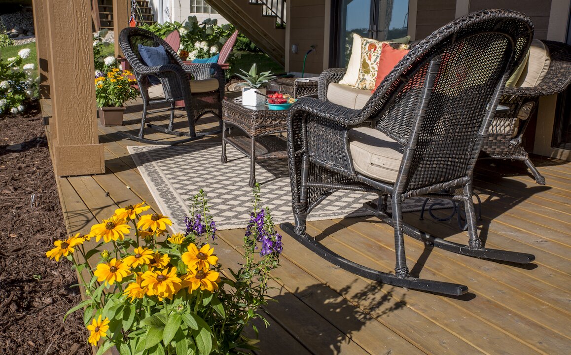 Cozy patio with wicker chairs and flowers