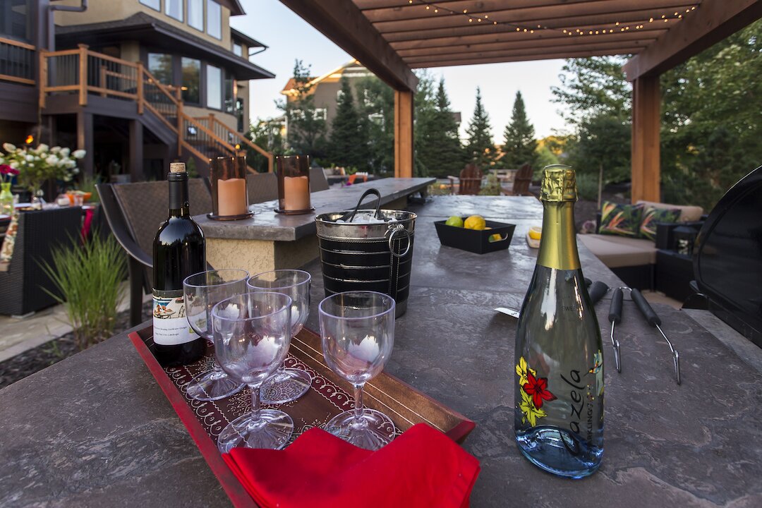 Outdoor patio with wine setup and seating area.