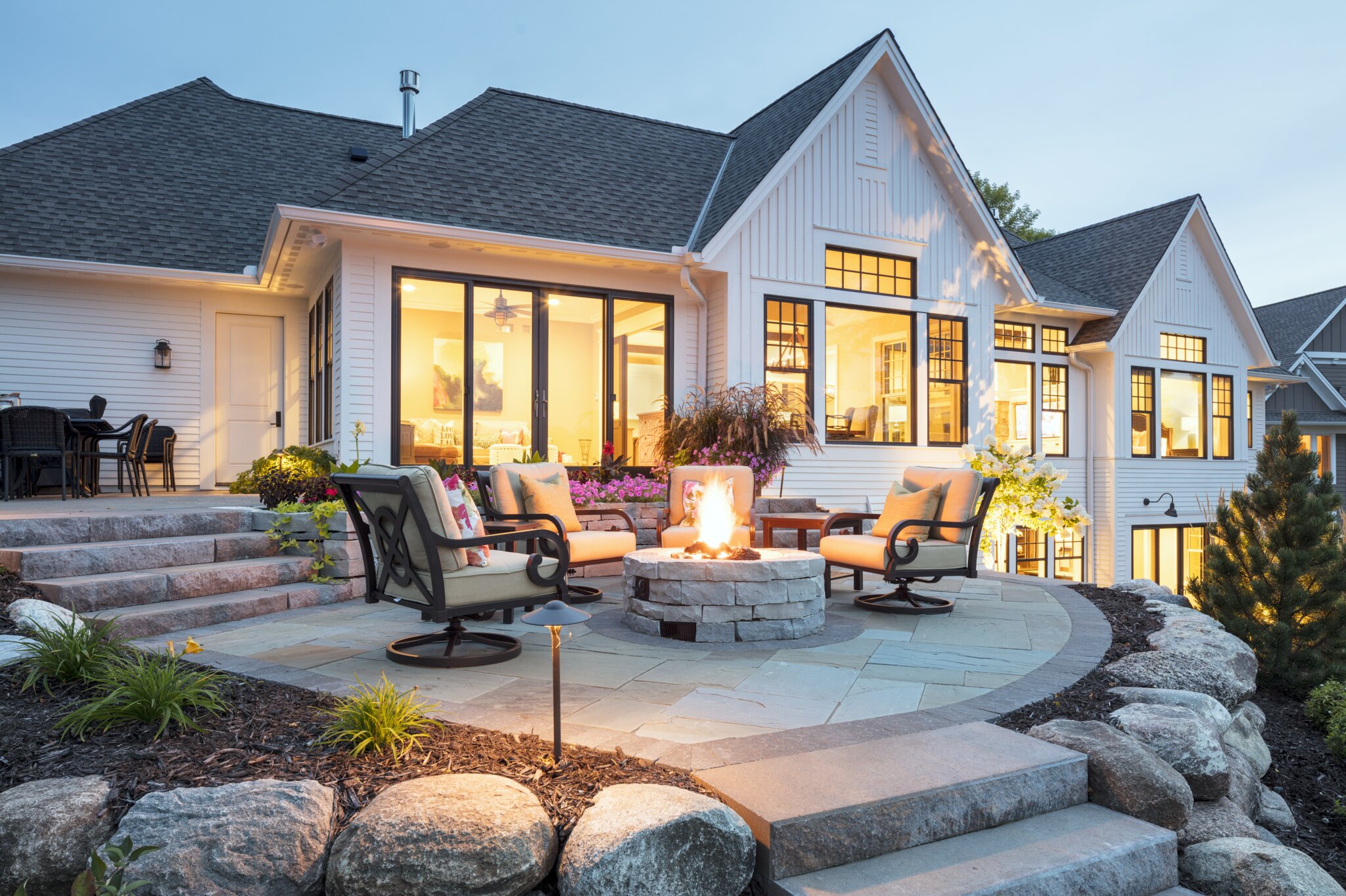 Cozy patio with firepit at modern suburban home.