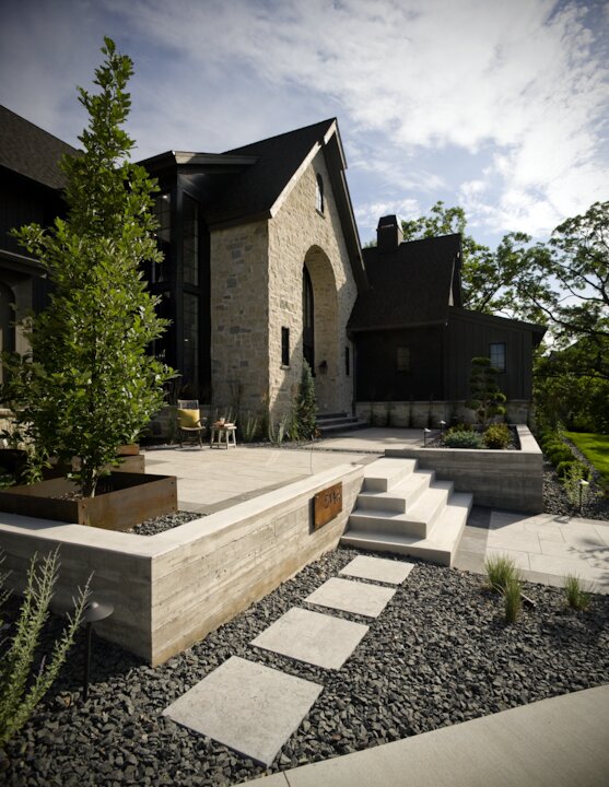 Modern home with stone exterior and landscaped garden.
