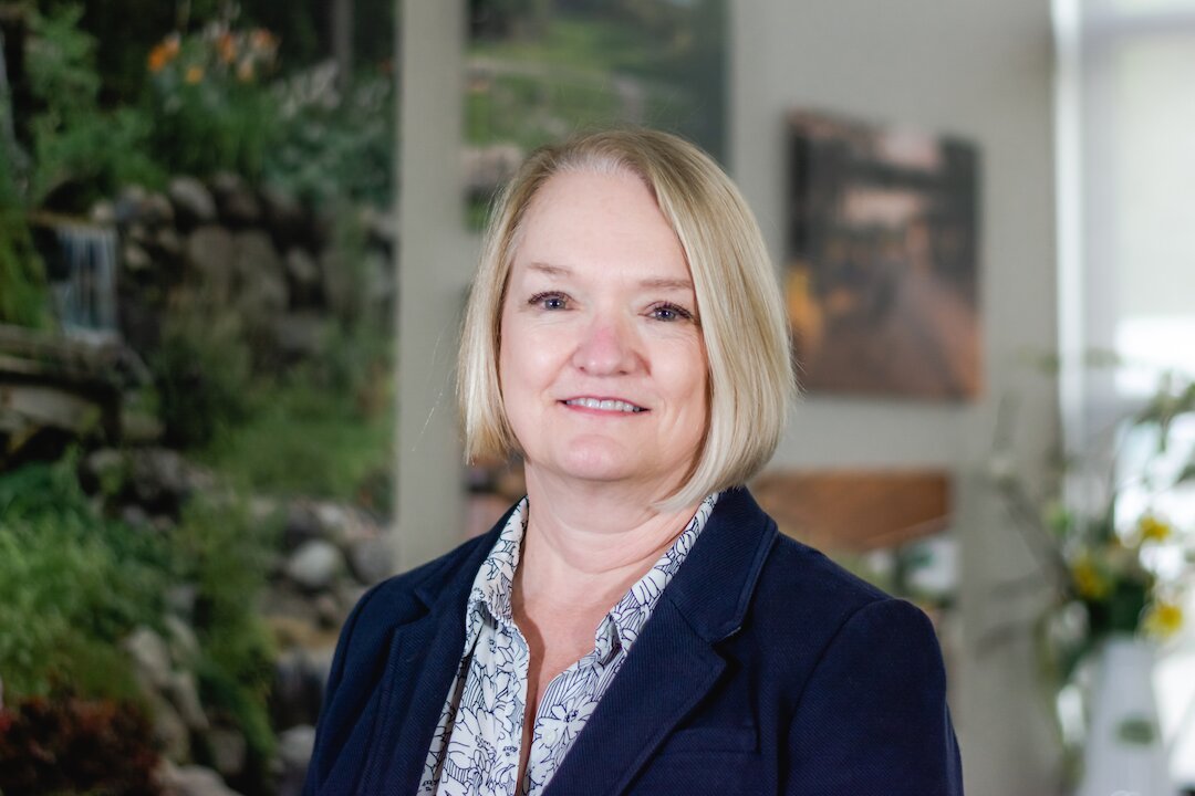 Smiling woman in office setting.