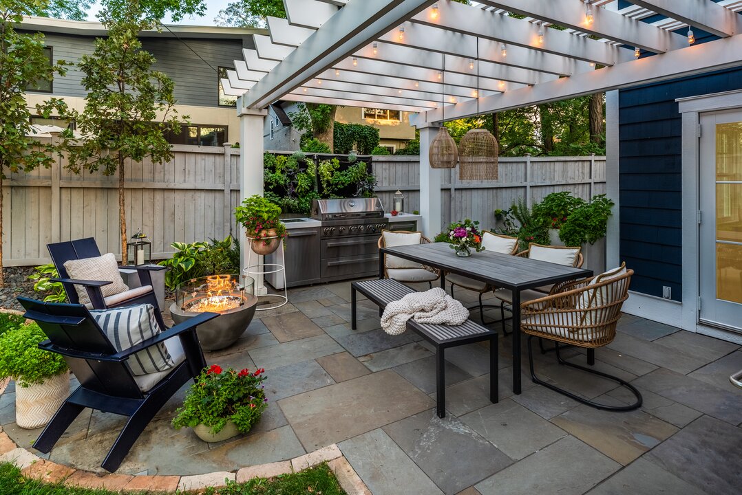 Cozy backyard patio with dining area and fire pit.