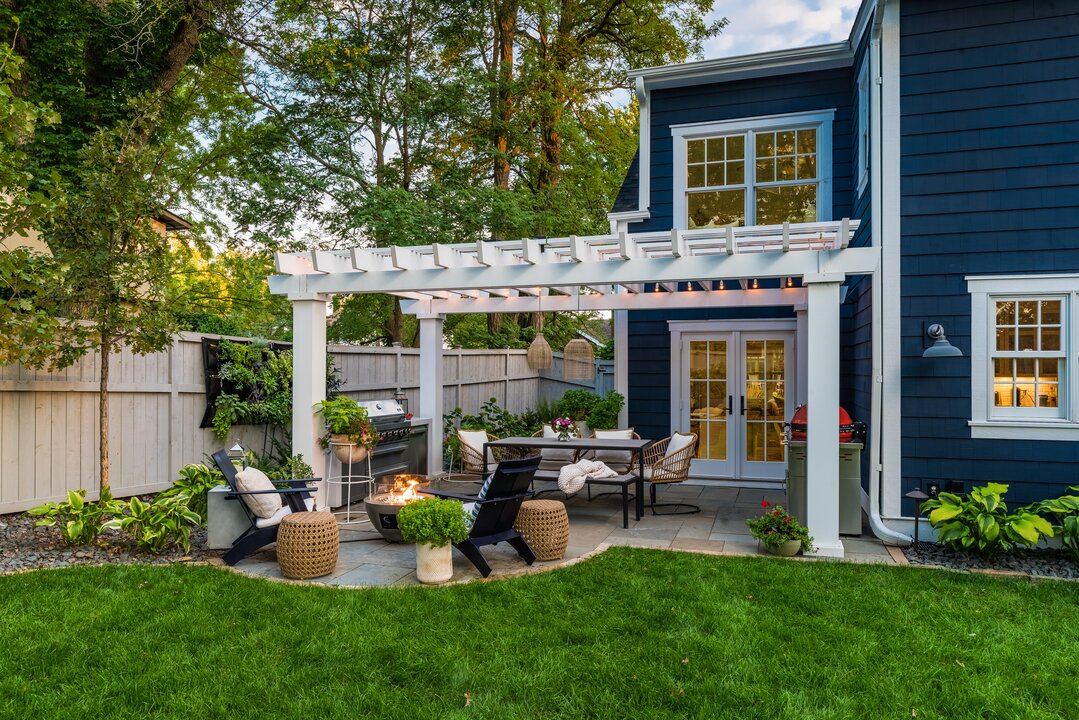 Charming backyard patio with pergola and fire pit.