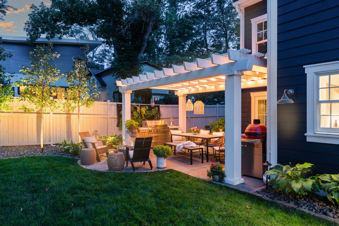 Cozy backyard patio with pergola and lighting