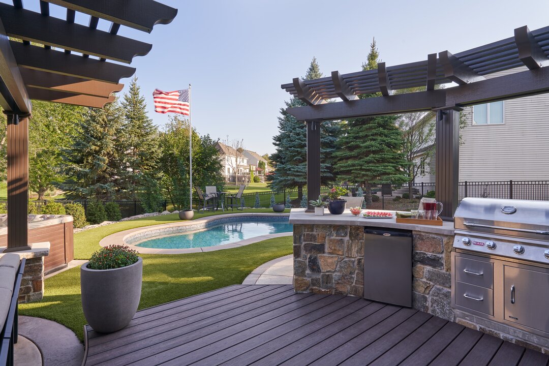 Backyard with pool, grill, and American flag.