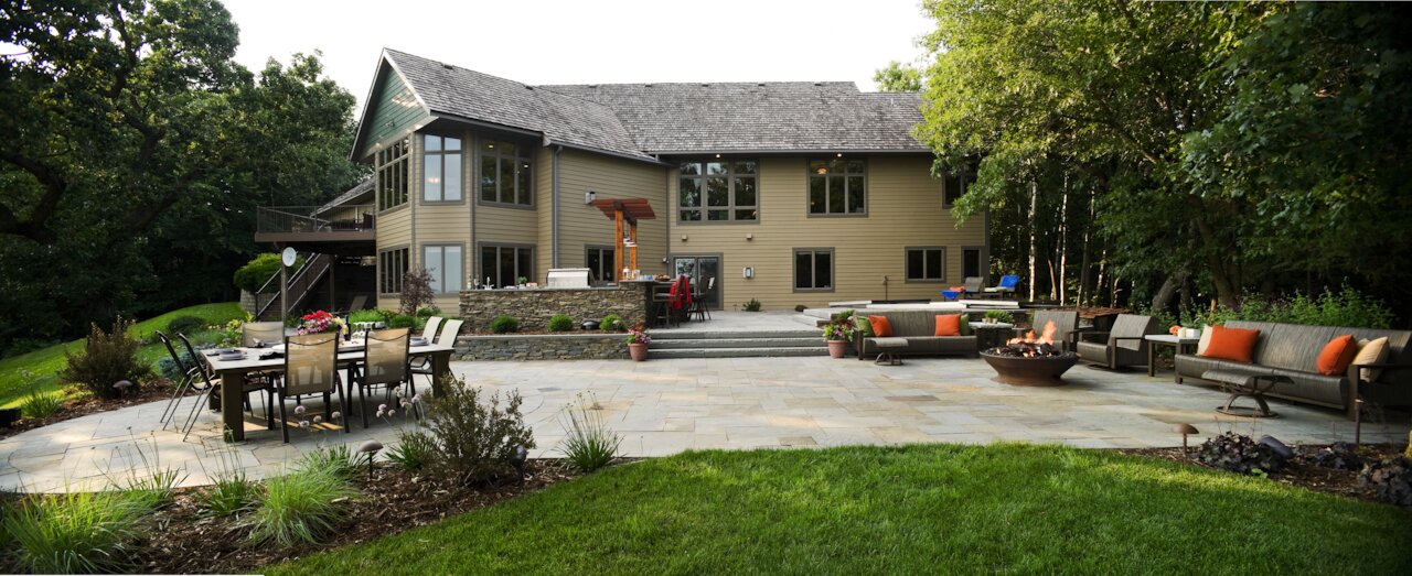 Spacious backyard with patio and fire pit setup.