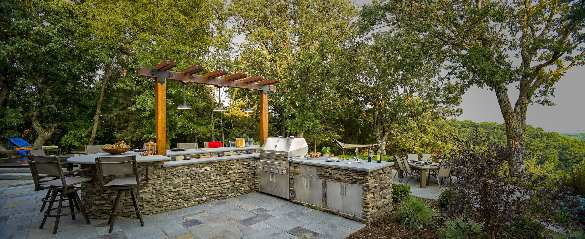 Outdoor kitchen with grill and dining area