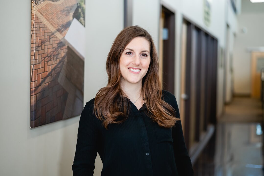 Woman smiling in office hallway