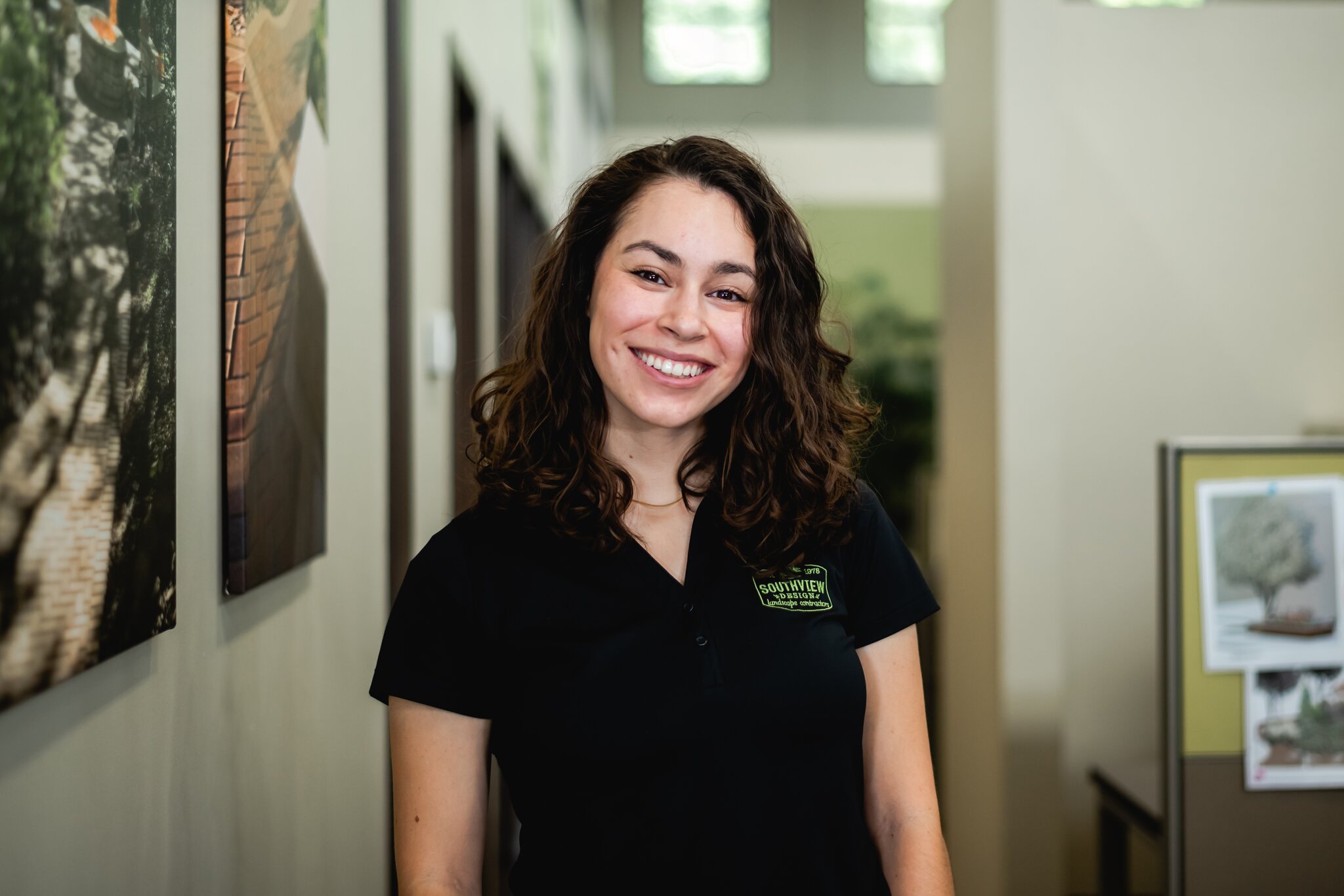 Smiling woman inside office environment.