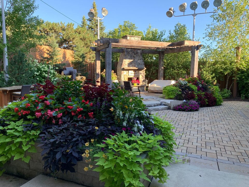 Garden patio with flowers and outdoor fireplace