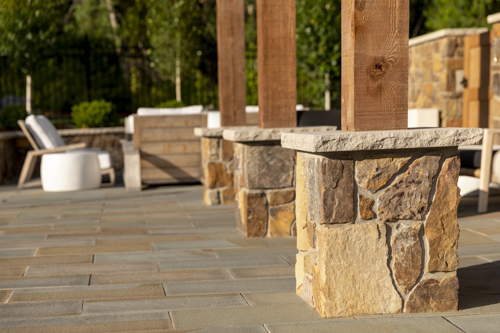 Outdoor patio with stone and wood elements.