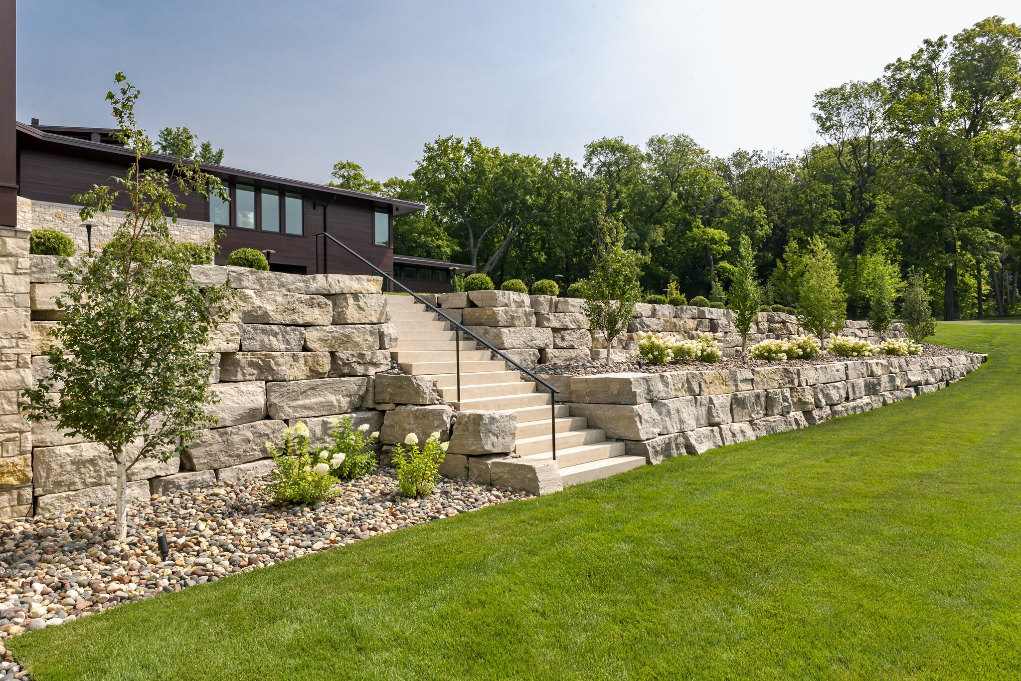 Stone retaining walls with stairs and landscaping