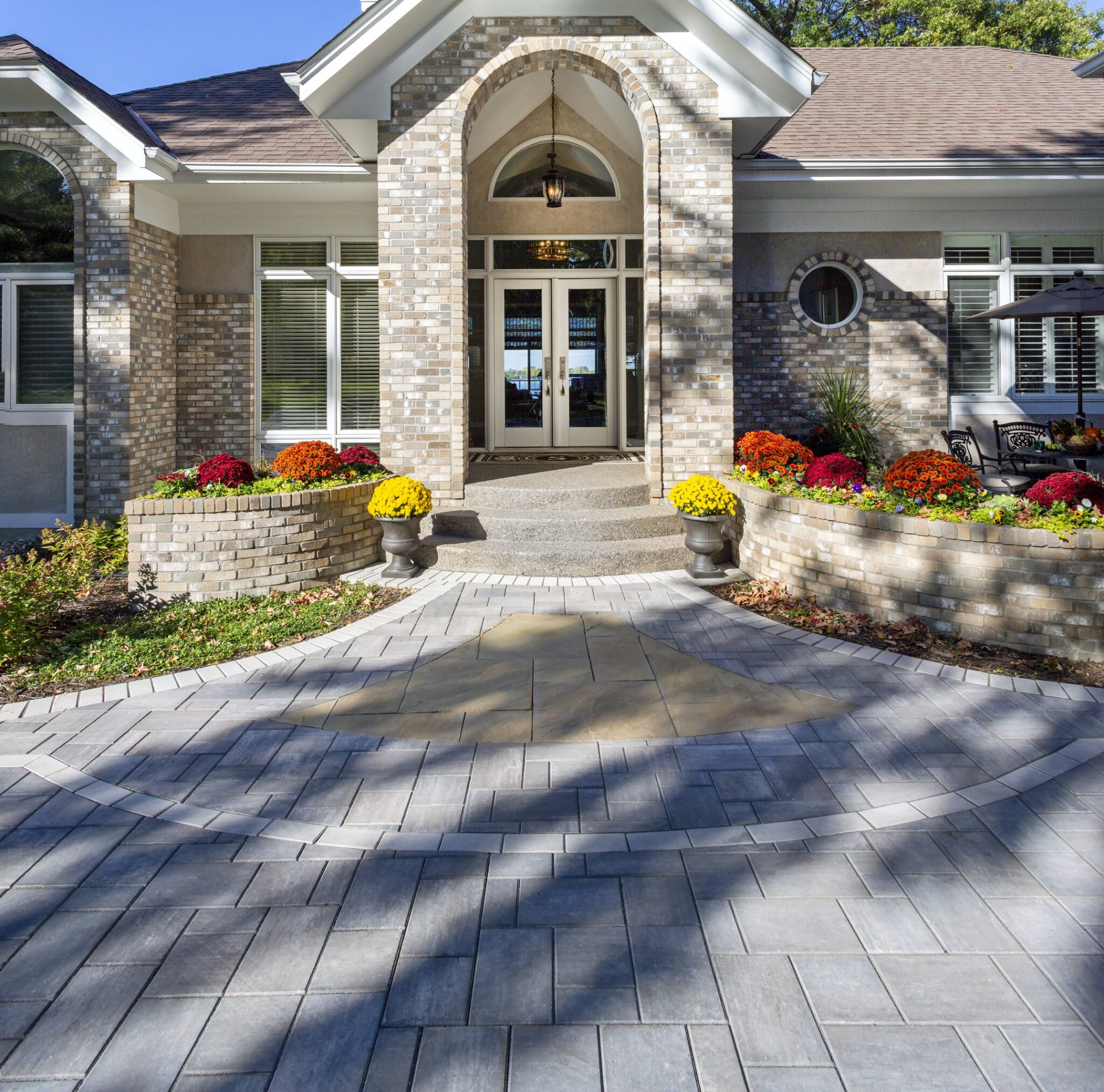 Elegant house entrance with colorful flowers.