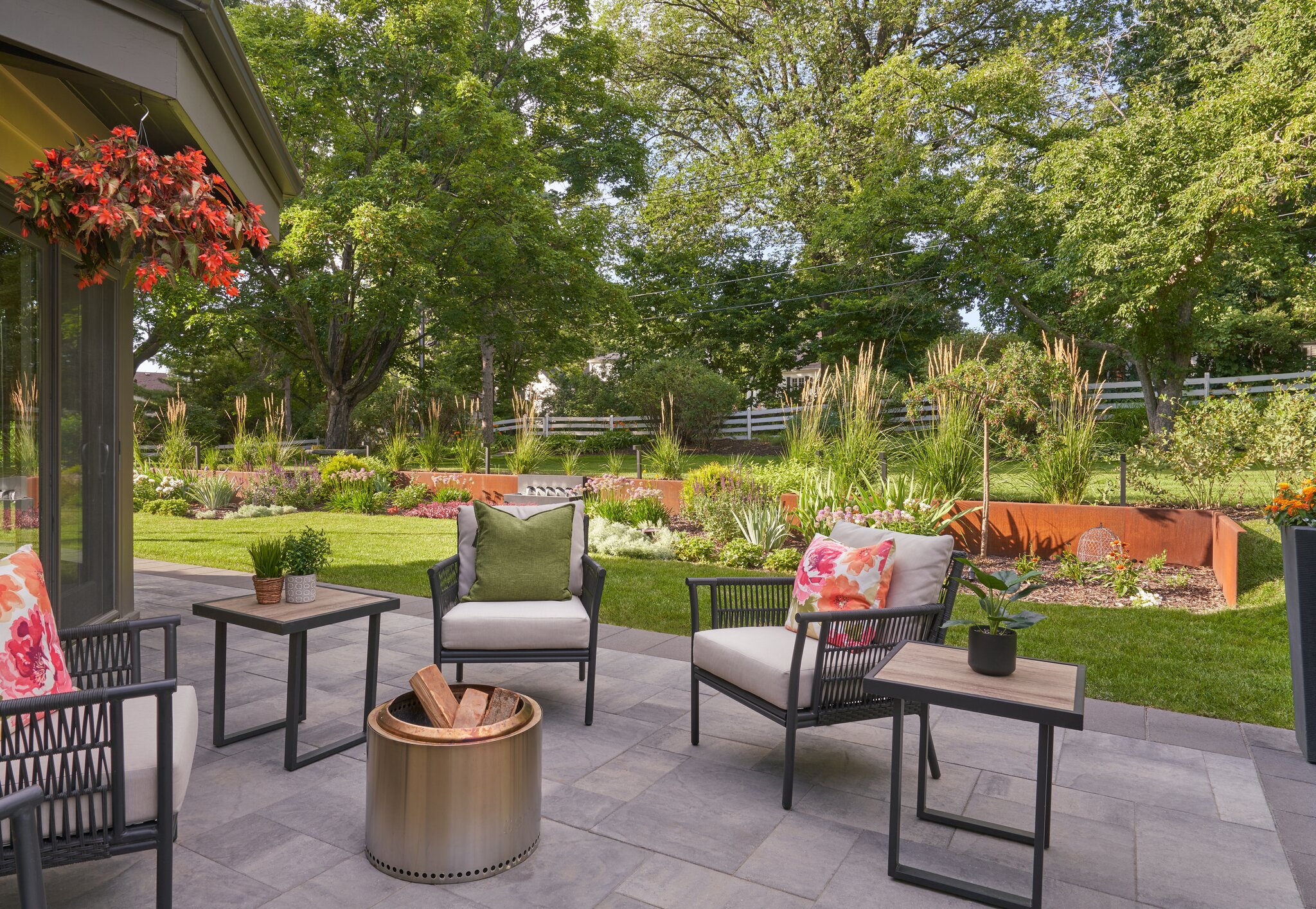 Cozy patio with garden view and seating area.