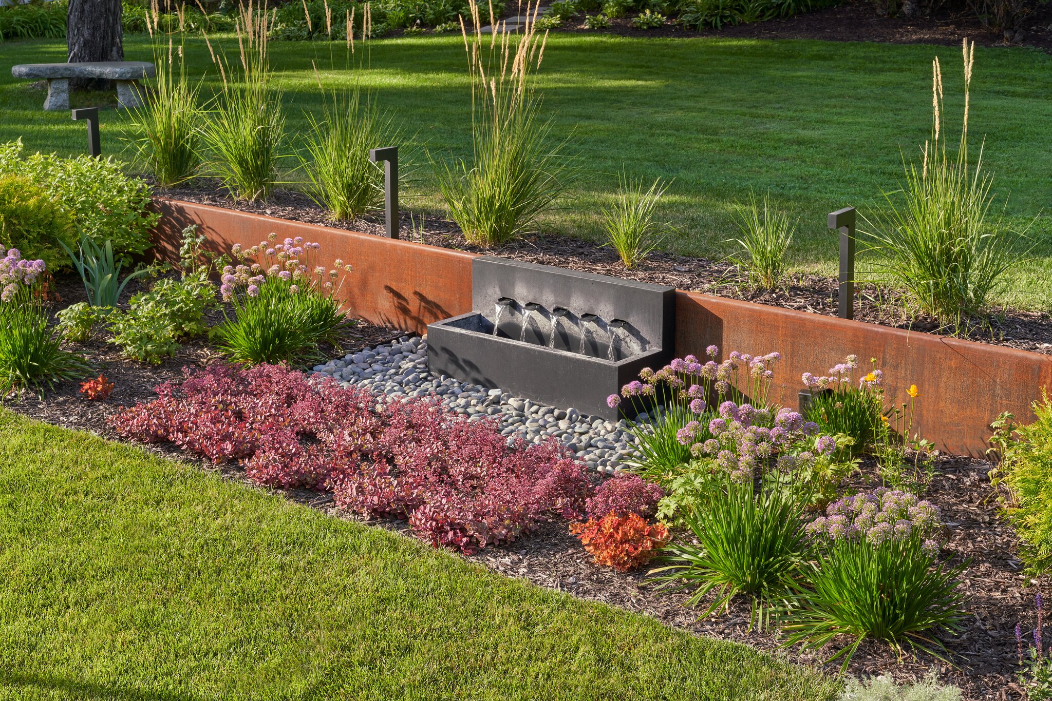 Garden fountain with flowers and plants