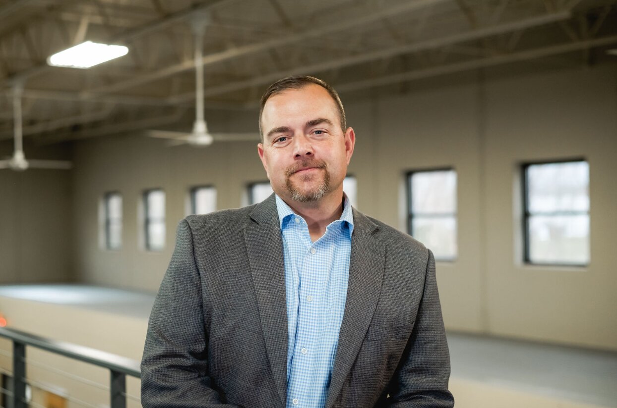 Man in gray suit standing indoors