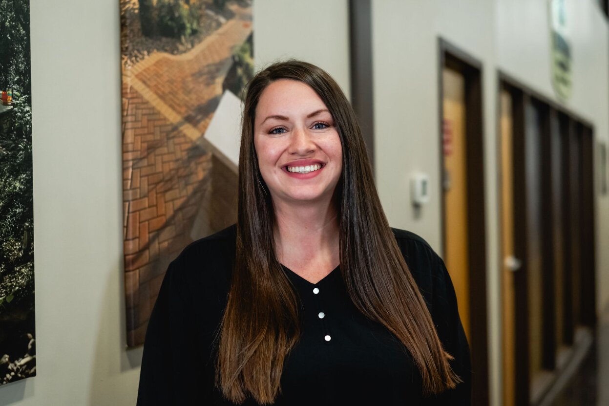 Smiling woman in an office setting.