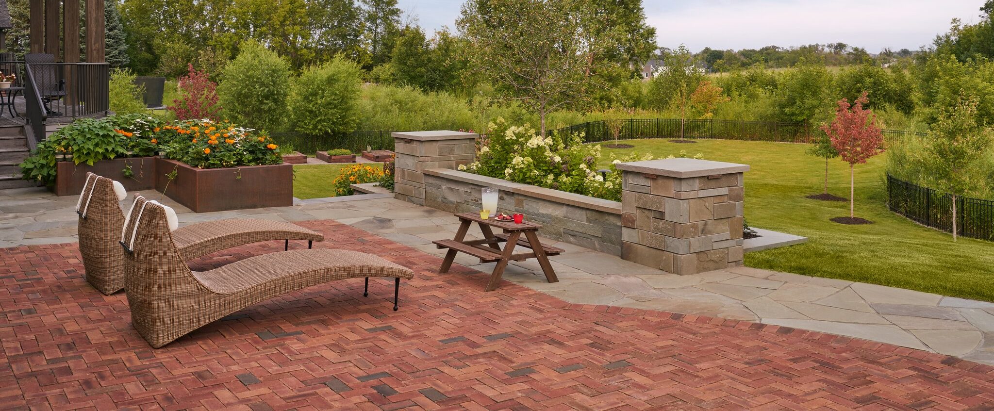 Backyard with patio chairs and landscaped garden view.