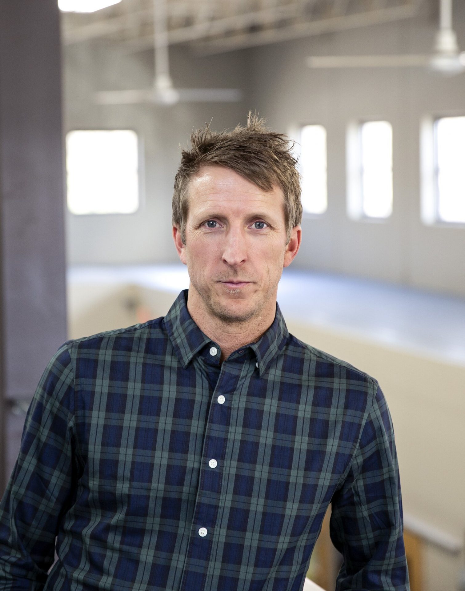 Man in plaid shirt indoors