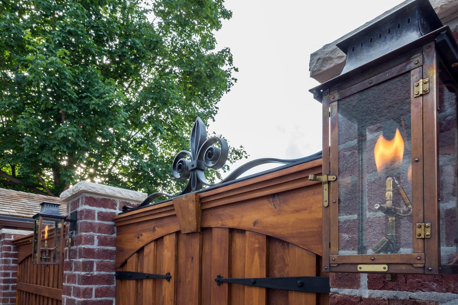Elegant wooden gate with ornate metal details.