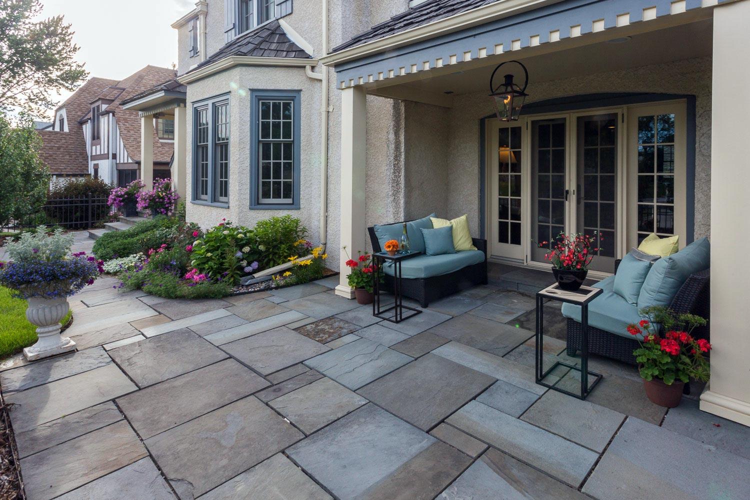 Charming patio with flowers and cozy seating area.