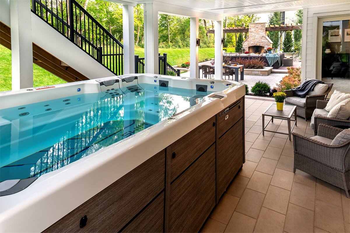 Outdoor patio with swim spa and seating area.