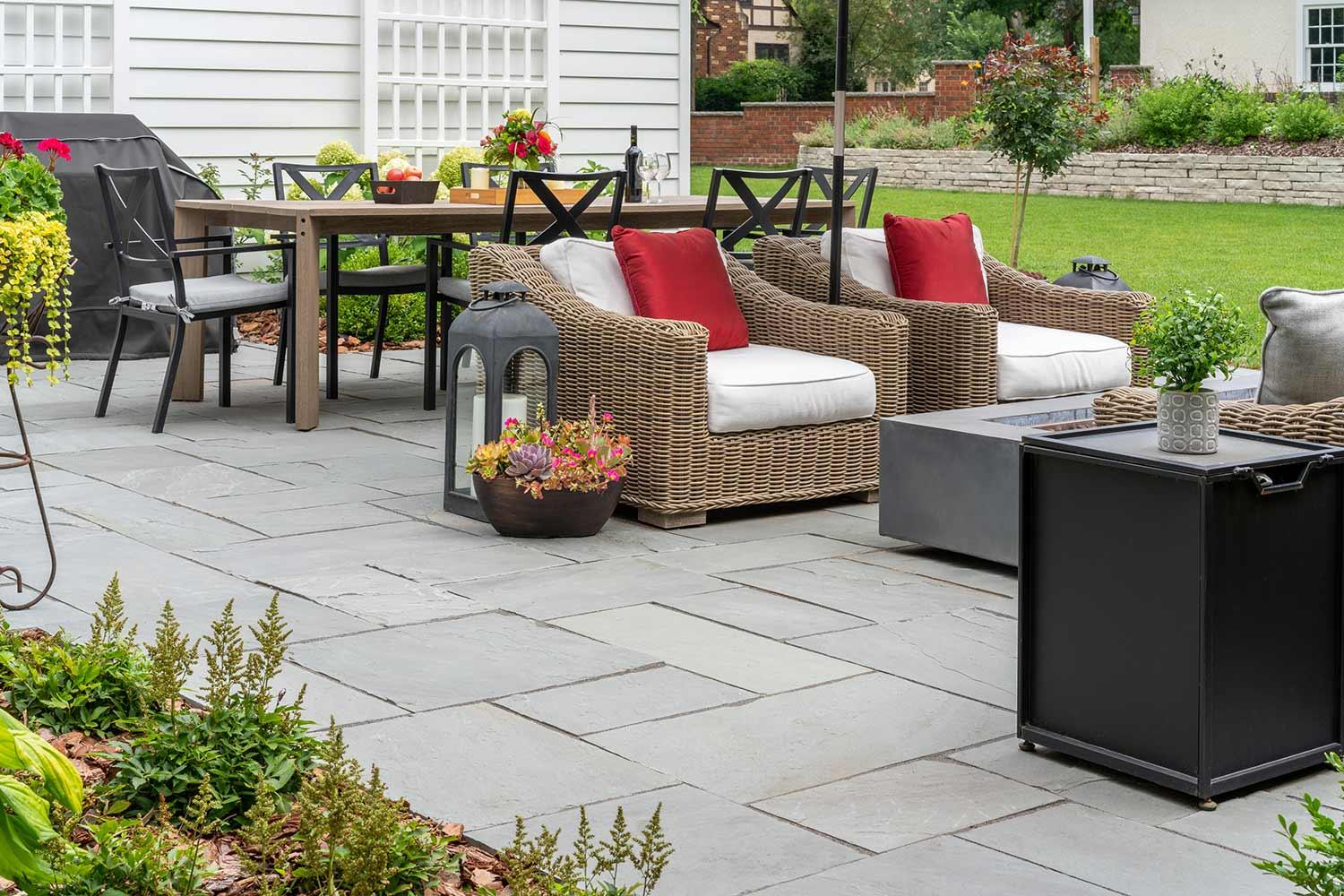 Outdoor patio with wicker furniture and dining area.