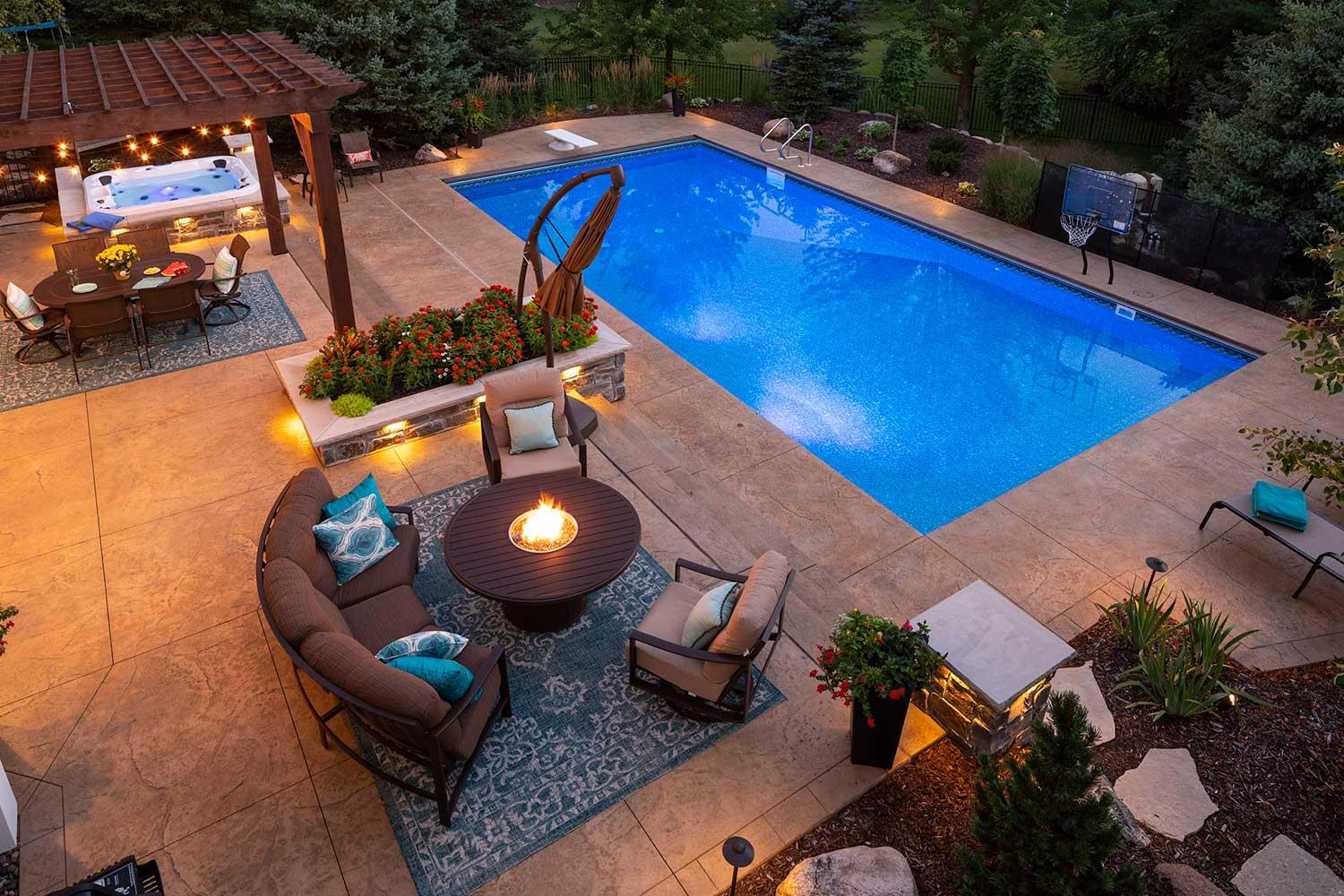 Luxury backyard with pool, hot tub, and firepit.