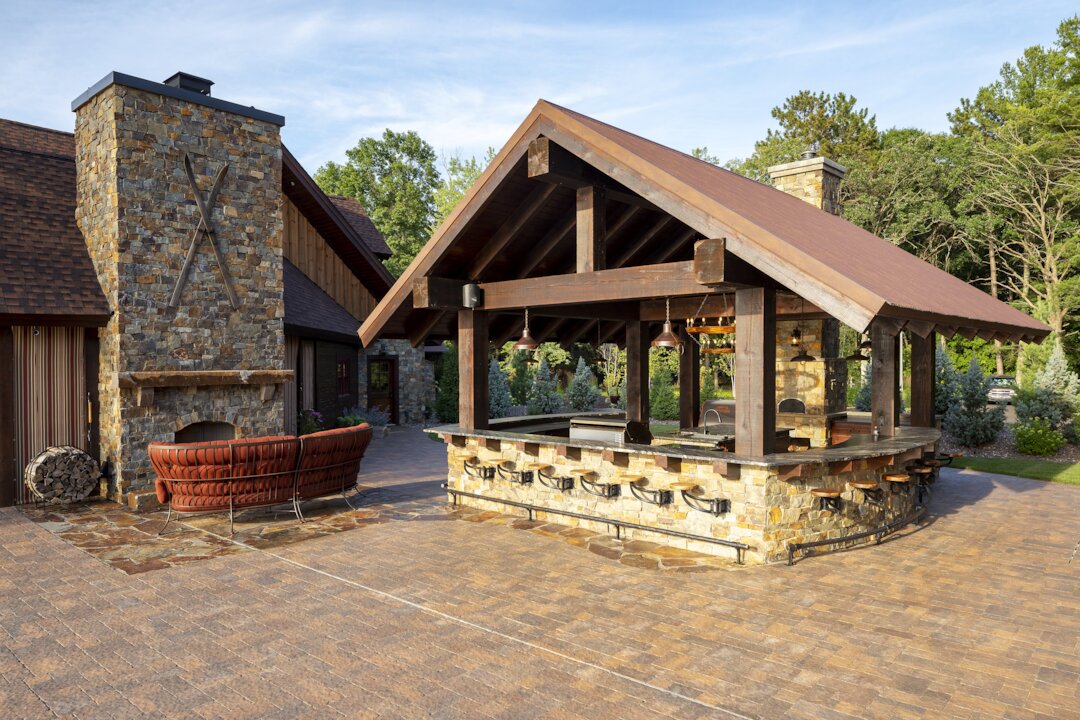 Outdoor kitchen with stone barbecue and fireplace