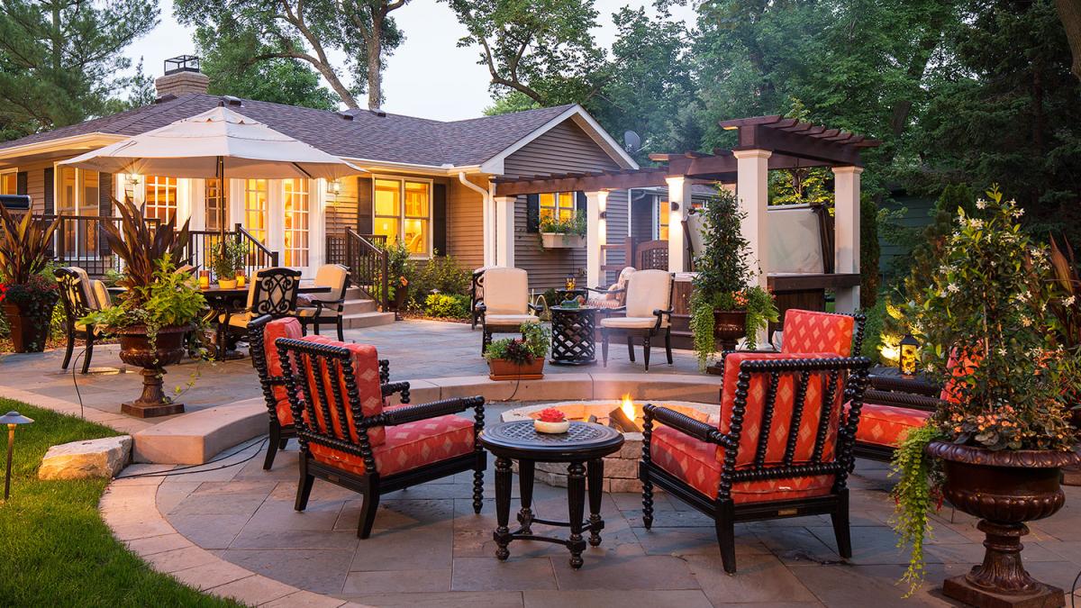 Cozy backyard patio with fire pit and furniture.