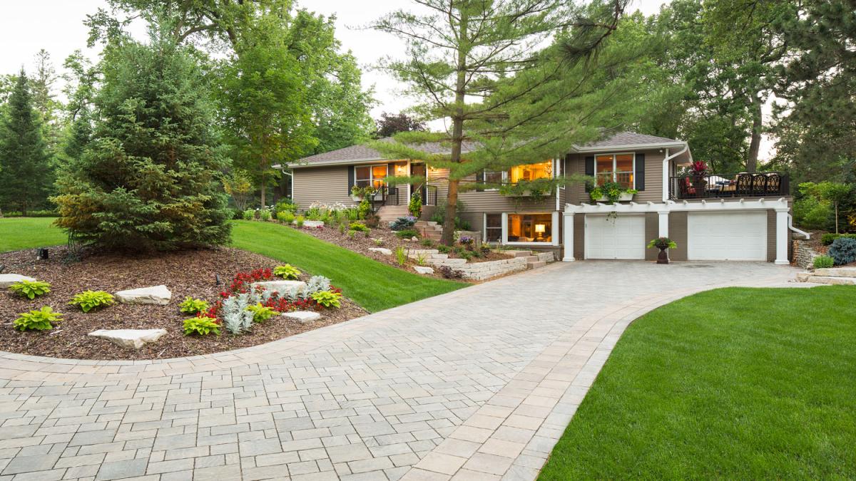 Modern house with landscaped yard and driveway.