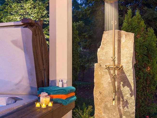 Outdoor shower with towels and candles