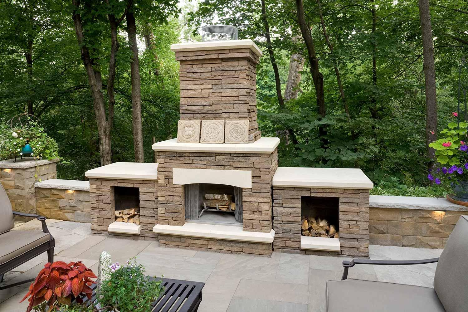 Outdoor stone fireplace with wood storage.