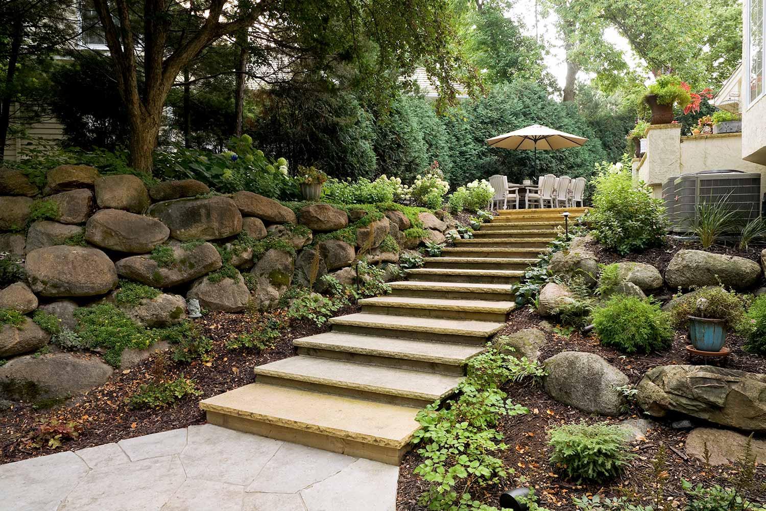 Garden stairs leading to outdoor dining area.