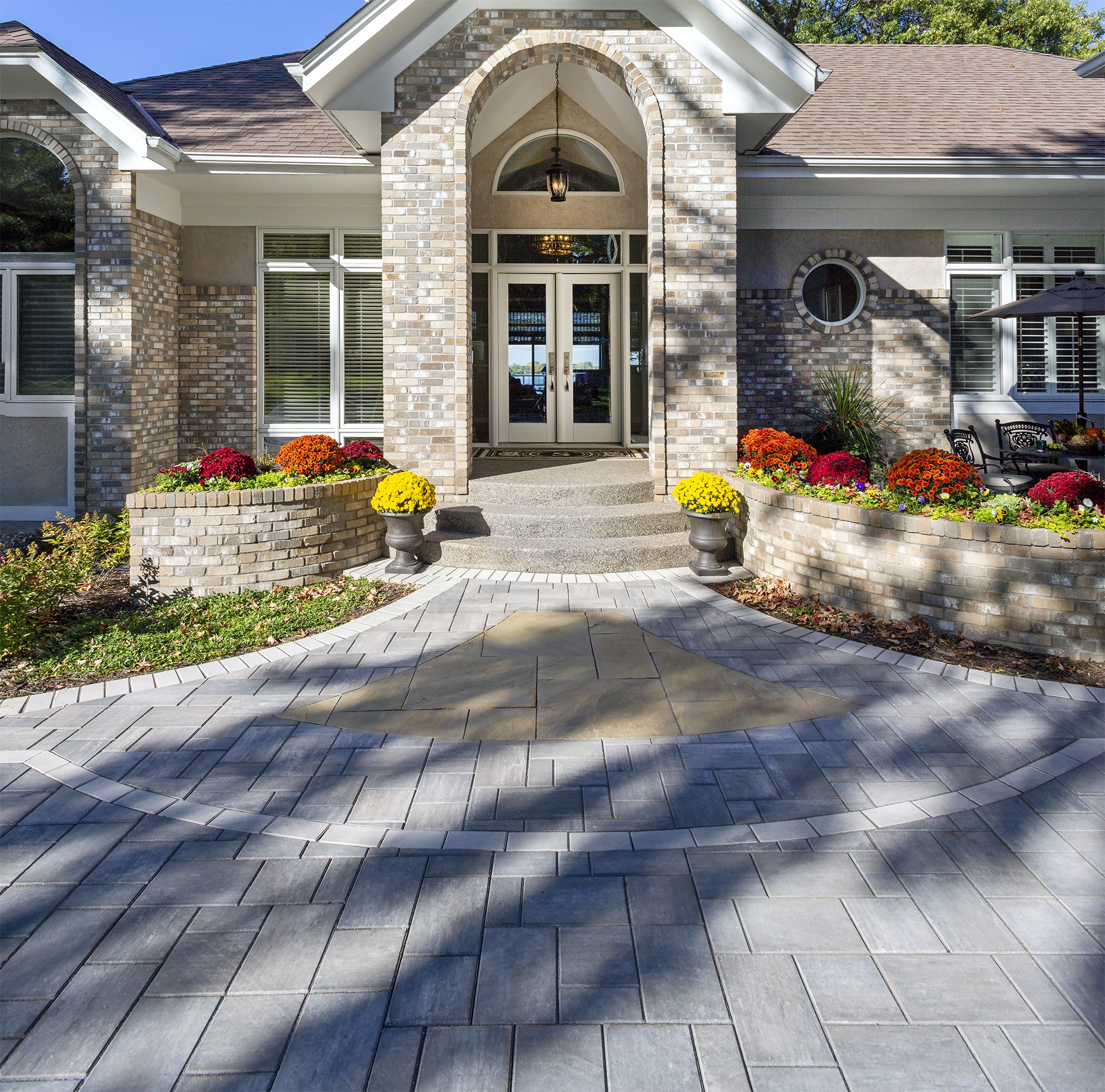 Modern house entrance with colorful flower pots