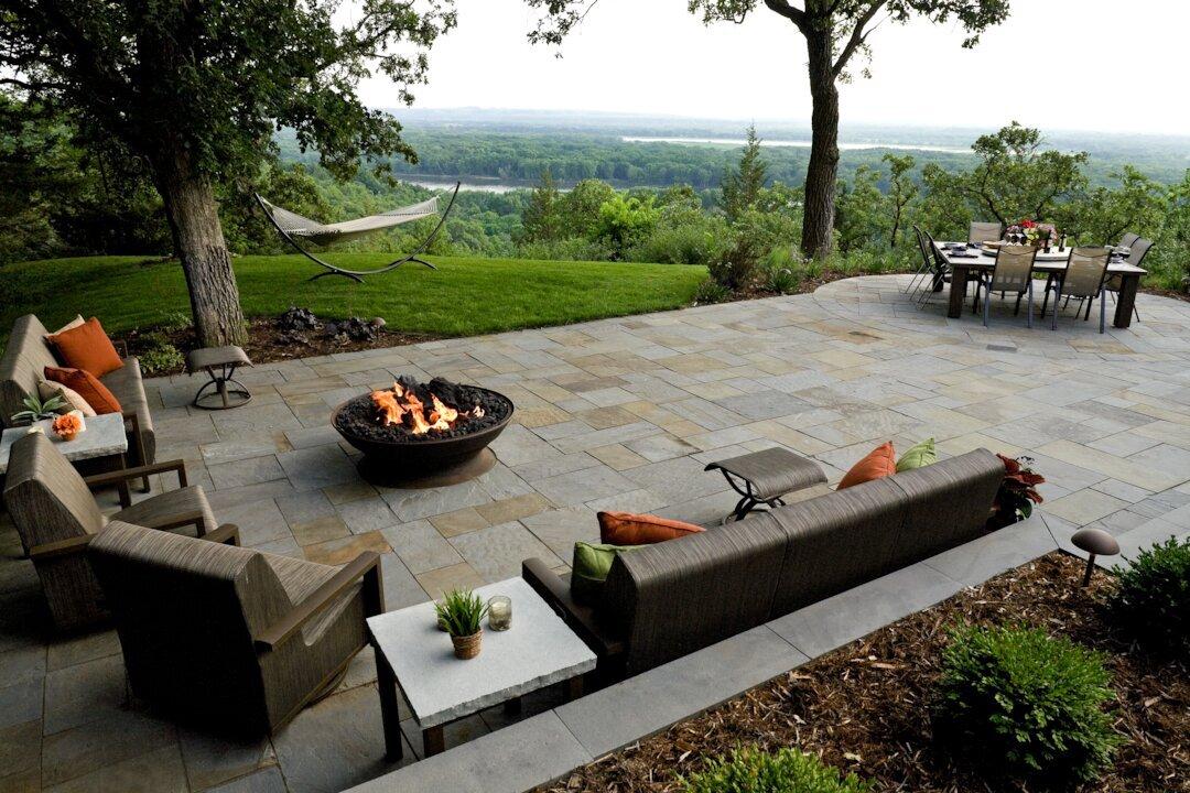 Scenic patio with fire pit and dining area.