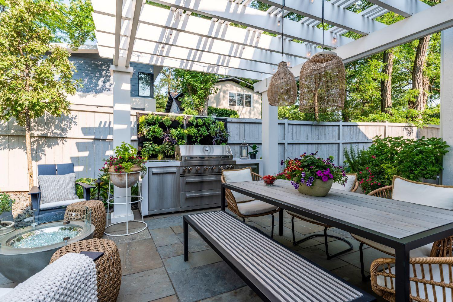 Outdoor patio with pergola, dining area, and grill.