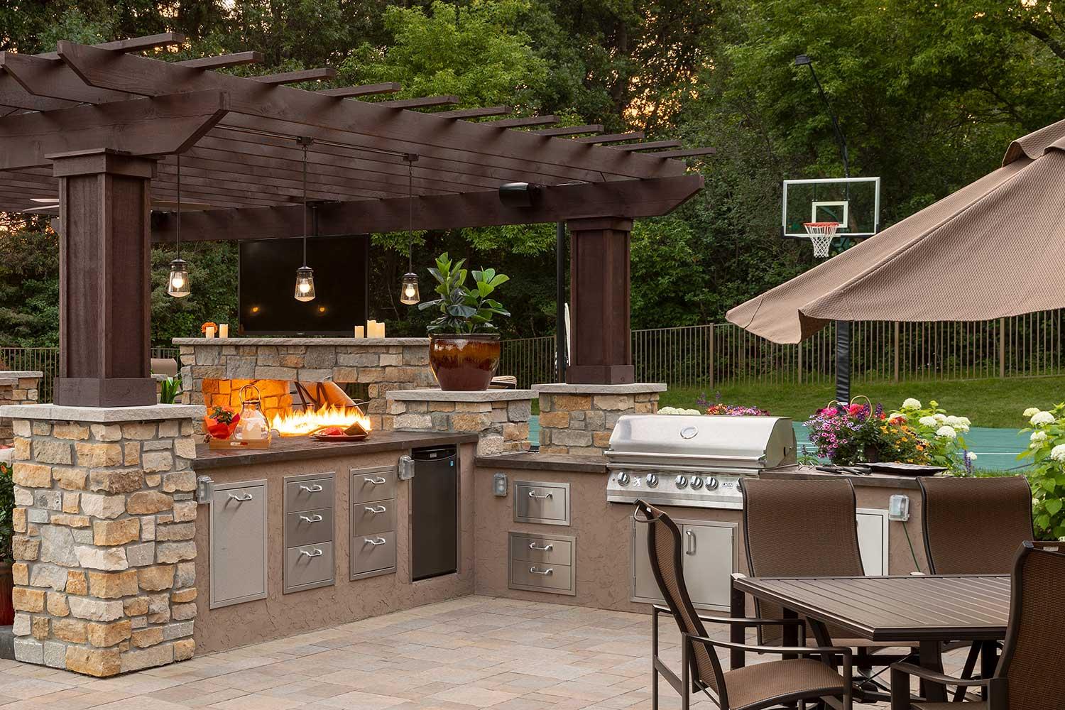 Outdoor kitchen with grill and pergola