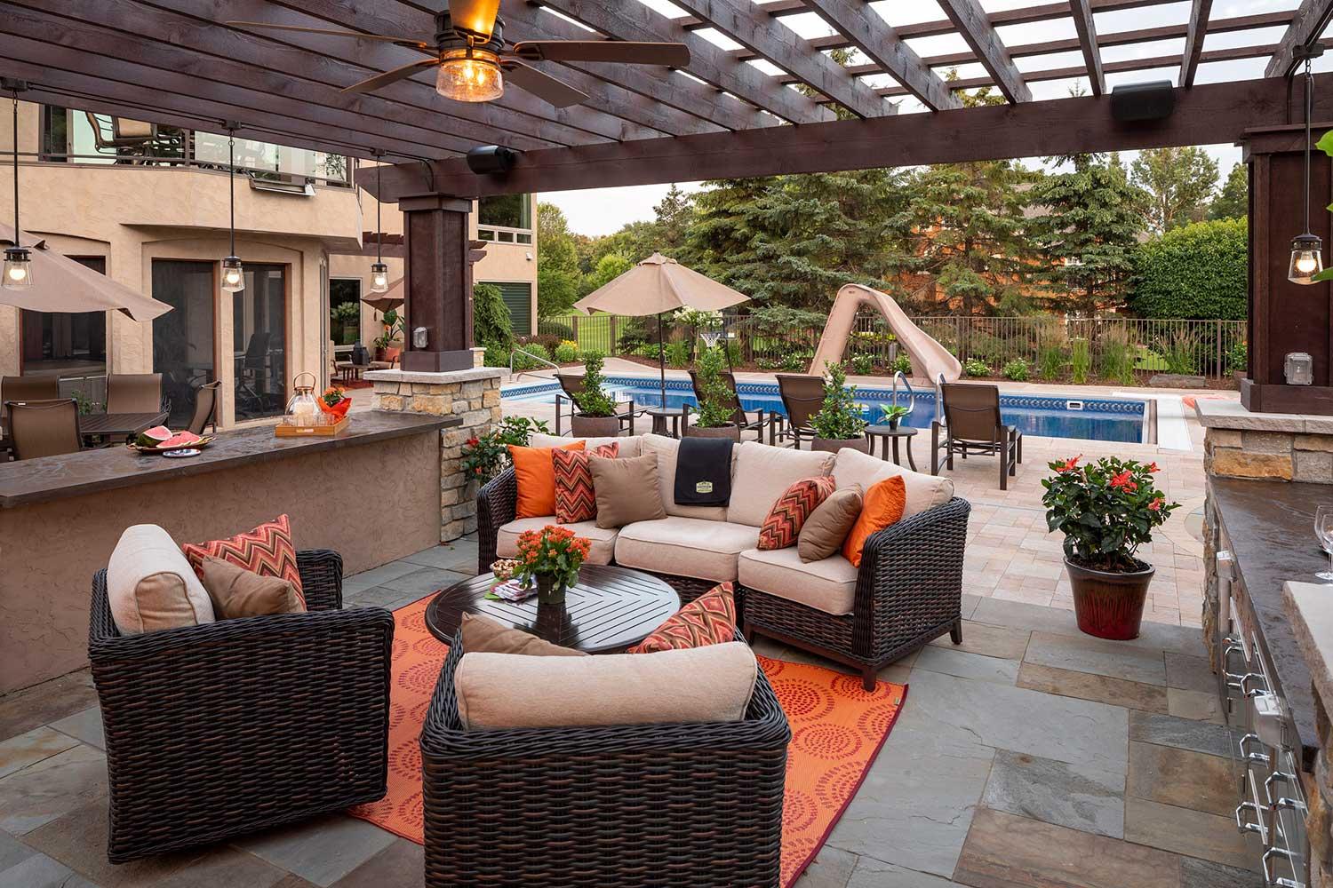 Outdoor patio with pool and lounge furniture.