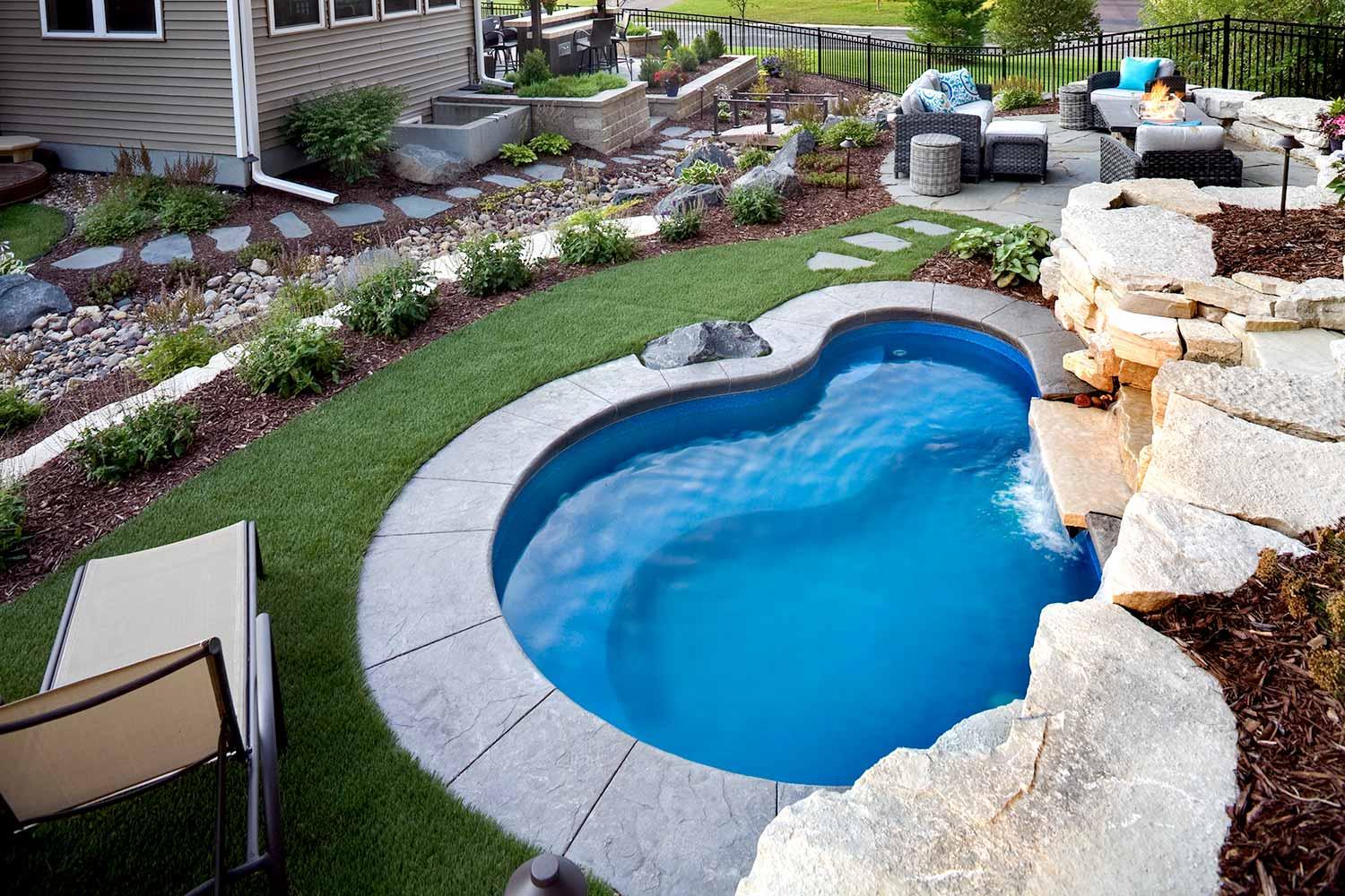 Backyard with small pool and seating area.