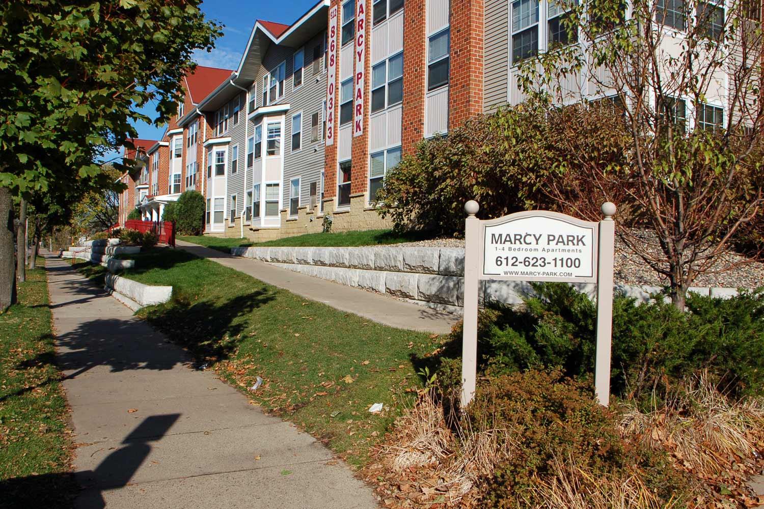 Marcy Park apartments exterior with contact sign.