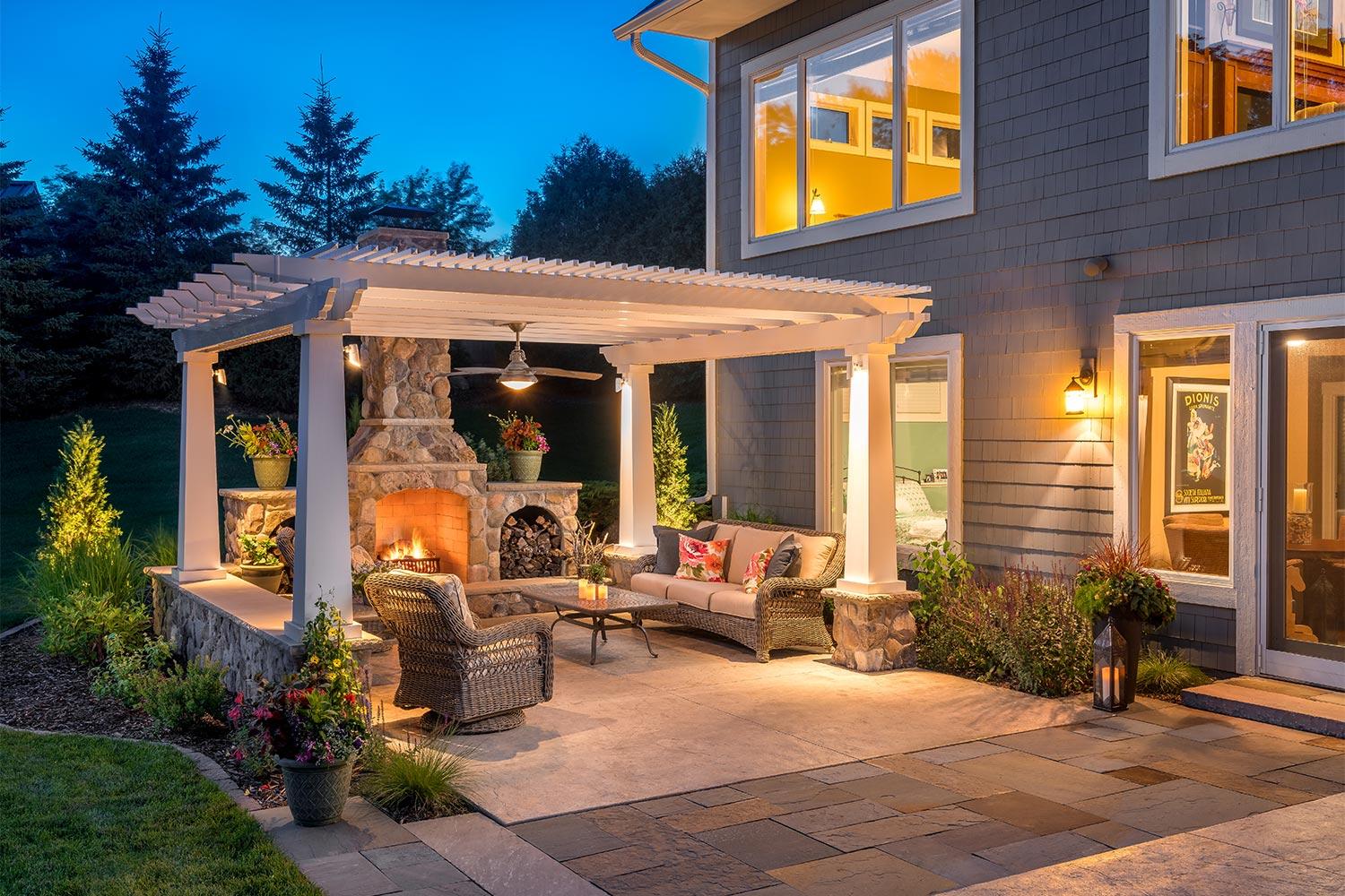 Cozy outdoor patio with fireplace and seating area.