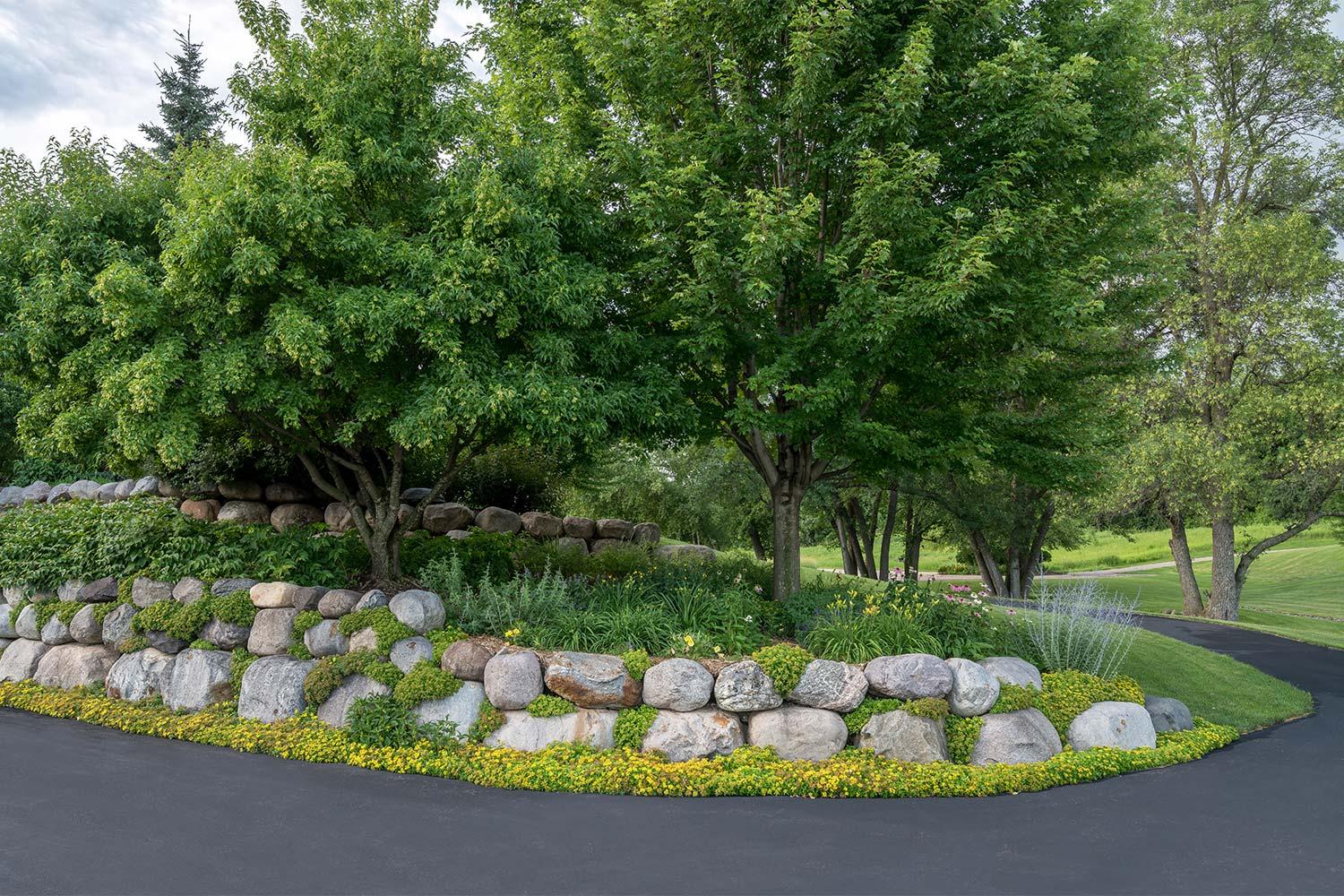 Lush garden with stone border and trees