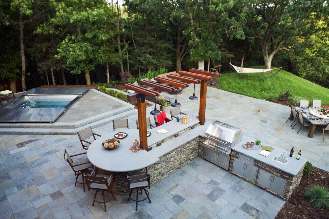 Outdoor kitchen with grill and seating area