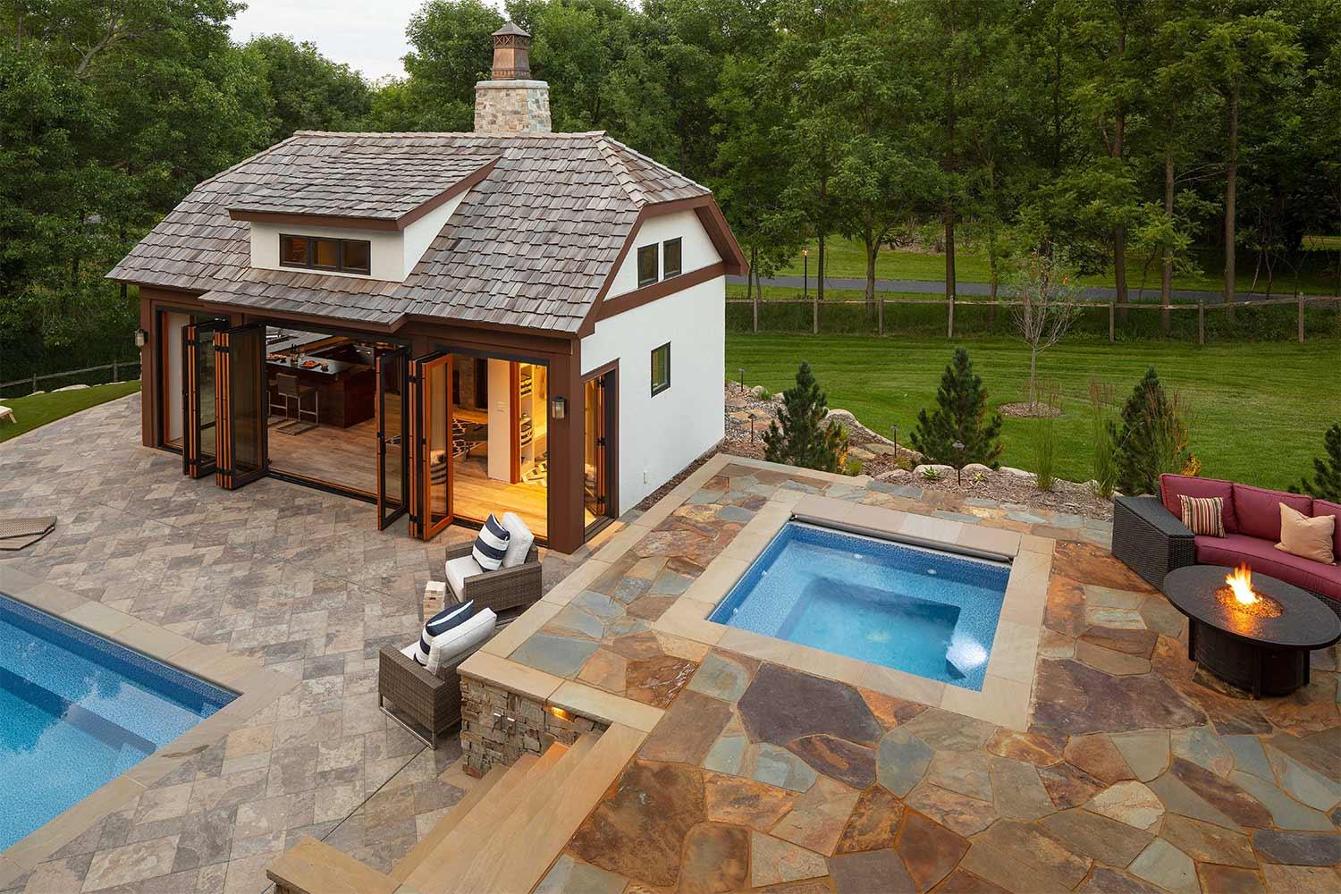 Luxury backyard with pool, hot tub, and patio.