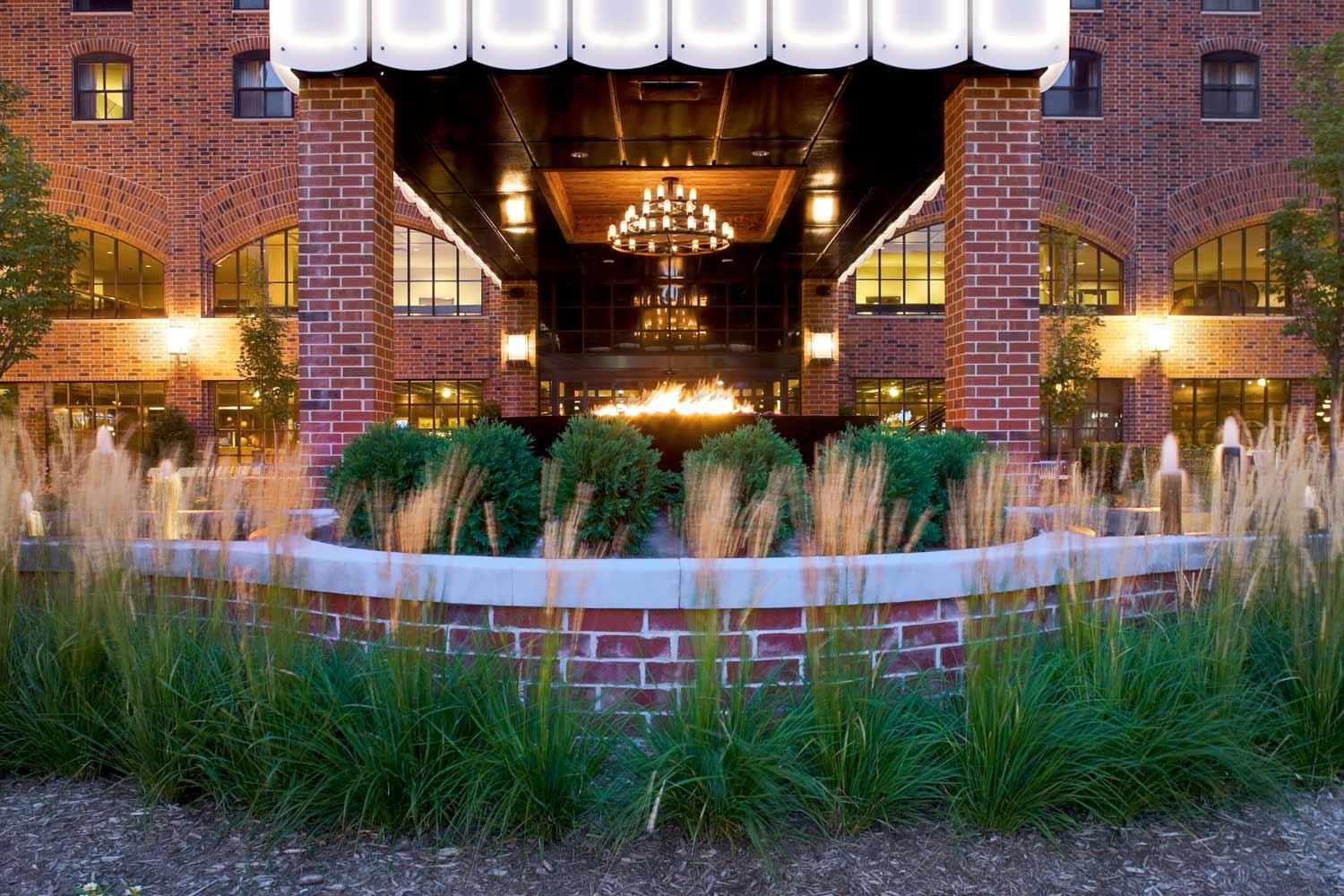 Hotel entrance with chandelier and brick facade
