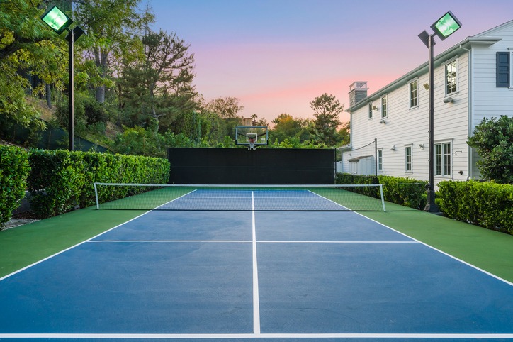 Residential tennis court at sunset