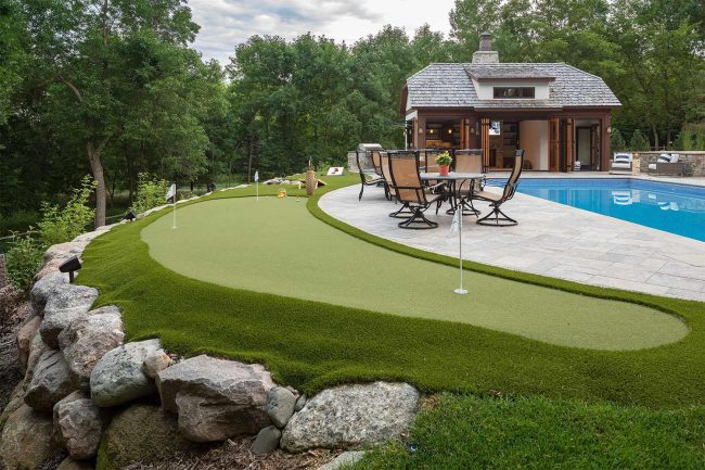 Backyard with putting green and pool.